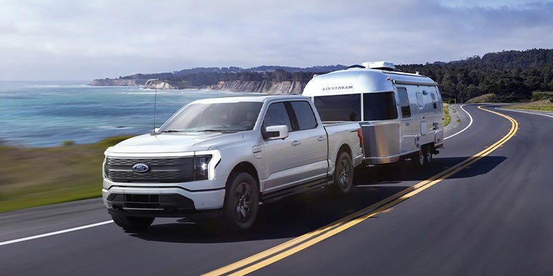 white 2022 Ford f-150_lightning towing